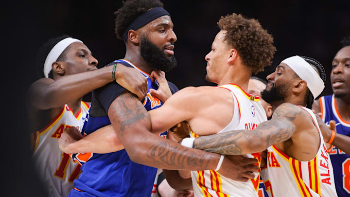 Apr 30, 2026; Atlanta, Georgia, USA; New York Knicks center Mitchell Robinson (23) scuffles with Atlanta Hawks guard Dyson Daniels (5) as forward Onyeka Okongwu (17) and guard Nickeil Alexander-Walker (7) attempt to hold them back in the second quarter during game six of the first round of the 2026 NBA Playoffs at State Farm Arena. Mandatory Credit: Brett Davis-Imagn Images