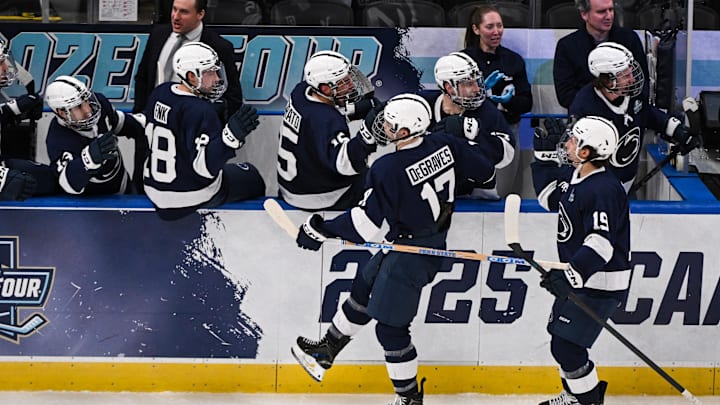 Apr 10, 2025; St. Louis, Missouri, UNITED STATES; Penn State Nittany Lions forward Nicholas DeGraves (17) celebrates with teammates after scoring a goal against the Boston University Terriers during the third period of the Frozen Four college ice hockey national semifinals at Enterprise Center. Mandatory Credit: Connor Hamilton-Imagn Images