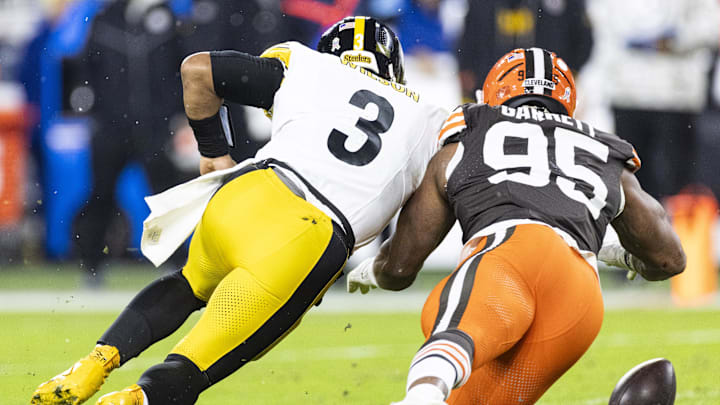 Nov 21, 2024; Cleveland, Ohio, USA; Pittsburgh Steelers quarterback Russell Wilson (3) and Cleveland Browns defensive end Myles Garrett (95) dive for a fumble during the second quarter at Huntington Bank Field Stadium. Mandatory Credit: Scott Galvin-Imagn Images
