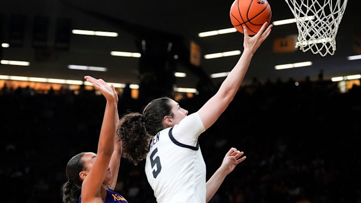 Iowa center Ava Heiden (5) lays the ball up as Ashland guard Lexi Howe (10) defends Oct. 30, 2025 during an exhibition game at Carver-Hawkeye Arena in Iowa City, Iowa. Iowa center Ava Heiden (5) lays the ball up as Ashland guard Lexi Howe (10) defends Oct. 30, 2025 during an exhibition game at Carver-Hawkeye Arena in Iowa City, Iowa.