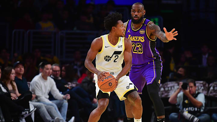 Nov 19, 2024; Los Angeles, California, USA; Utah Jazz guard Collin Sexton (2) moves the ball against Los Angeles Lakers forward LeBron James (23) during the first half at Crypto.com Arena. Mandatory Credit: Gary A. Vasquez-Imagn Images