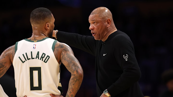 Mar 8, 2024; Los Angeles, California, USA;  Milwaukee Bucks head coach Doc Rivers talks to guard Damian Lillard (0) during the third quarter of the NBA game against the Los Angeles Lakers at Crypto.com Arena. Mandatory Credit: Kiyoshi Mio-Imagn Images