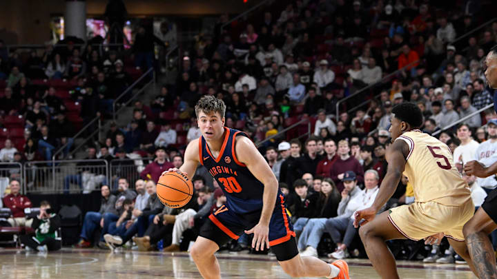 Jan 31, 2026; Chestnut Hill, Massachusetts, USA; Virginia Cavaliers guard Dallin Hall (30) dribbles the ball against Boston College Eagles guard Fred Payne (5) during the second half at Conte Forum. Mandatory Credit: Eric Canha-Imagn Images