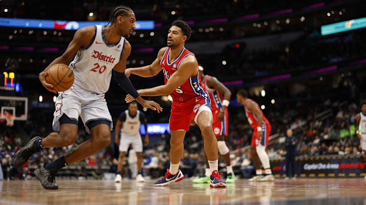 Apr 9, 2025; Washington, District of Columbia, USA; Washington Wizards forward Alex Sarr (20) dribbles the ball as Philadelphia 76ers guard Quentin Grimes (5) defends in the second half at Capital One Arena. Mandatory Credit: Geoff Burke-Imagn Images