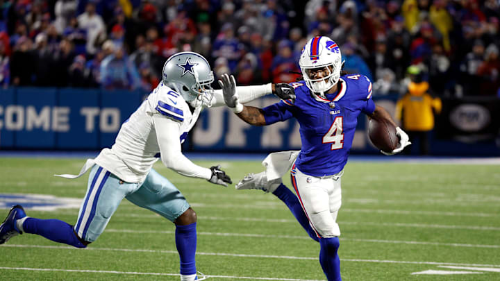 Buffalo Bills running back James Cook (4) tries to get around Dallas Cowboys cornerback Jourdan Lewis (2). Cook rushed for 179 yards.