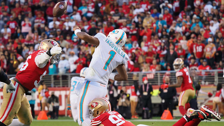 Dec 4, 2022; Santa Clara, California, USA; San Francisco 49ers defensive end Nick Bosa (97) forces a fumble against Miami Dolphins quarterback Tua Tagovailoa (1) during the fourth quarter at Levi's Stadium. Mandatory Credit: Kelley L Cox-Imagn Images
