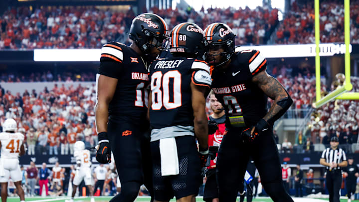 Dec 2, 2023; Arlington, TX, USA; Oklahoma State Cowboys wide receiver Brennan Presley (80) celebrates with teammates after scoring a touchdown during the first half against the Texas Longhorns at AT&T Stadium. Mandatory Credit: Kevin Jairaj-USA TODAY Sports Dec 2, 2023; Arlington, TX, USA; Oklahoma State Cowboys wide receiver Brennan Presley (80) celebrates with teammates after scoring a touchdown during the first half against the Texas Longhorns at AT&T Stadium. Mandatory Credit: Kevin Jairaj-USA TODAY Sports