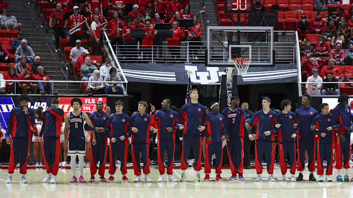 Jan 3, 2026; Salt Lake City, Utah, USA; The Arizona Wildcats stand for the Nation Anthem before the game against the Utah Utes at Jon M. Huntsman Center. Mandatory Credit: Rob Gray-Imagn Images Jan 3, 2026; Salt Lake City, Utah, USA; The Arizona Wildcats stand for the Nation Anthem before the game against the Utah Utes at Jon M. Huntsman Center. Mandatory Credit: Rob Gray-Imagn Images