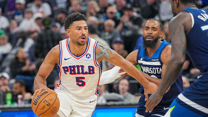 Mar 4, 2025; Minneapolis, Minnesota, USA; Philadelphia 76ers guard Quentin Grimes (5) dribbles against the Minnesota Timberwolves guard Mike Conley (10) in the third quarter at Target Center. Mandatory Credit: Brad Rempel-Imagn Images