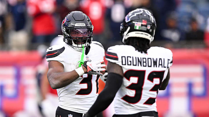 Oct 13, 2024; Foxborough, Massachusetts, USA; Houston Texans running back Dameon Pierce (31) celebrates with running back Dare Ogunbowale (33) after scoring a touchdown against the New England Patriots during the first half at Gillette Stadium. Mandatory Credit: Brian Fluharty-Imagn Images
