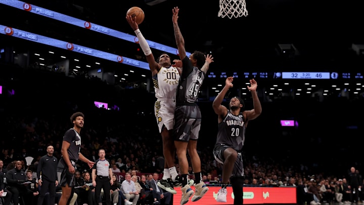 Dec 4, 2024; Brooklyn, New York, USA; Indiana Pacers guard Bennedict Mathurin (00) drives to the basket against Brooklyn Nets guard Keon Johnson (45) and center Day'Ron Sharpe (20) and forward Cameron Johnson (2) during the second quarter at Barclays Center. Mandatory Credit: Brad Penner-Imagn Images Dec 4, 2024; Brooklyn, New York, USA; Indiana Pacers guard Bennedict Mathurin (00) drives to the basket against Brooklyn Nets guard Keon Johnson (45) and center Day'Ron Sharpe (20) and forward Cameron Johnson (2) during the second quarter at Barclays Center. Mandatory Credit: Brad Penner-Imagn Images