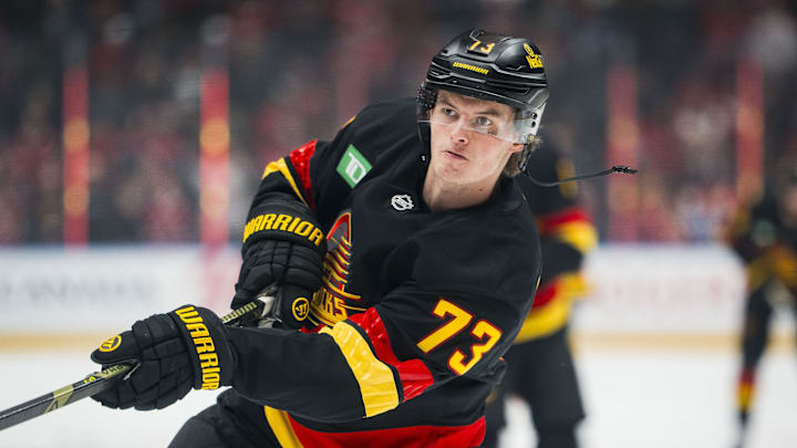 Oct 25, 2025; Vancouver, British Columbia, CAN; Vancouver Canucks forward Lukas Reichel (73) shoots in warm up prior to a game against the Montreal Canadiens at Rogers Arena. Mandatory Credit: Bob Frid-Imagn Images