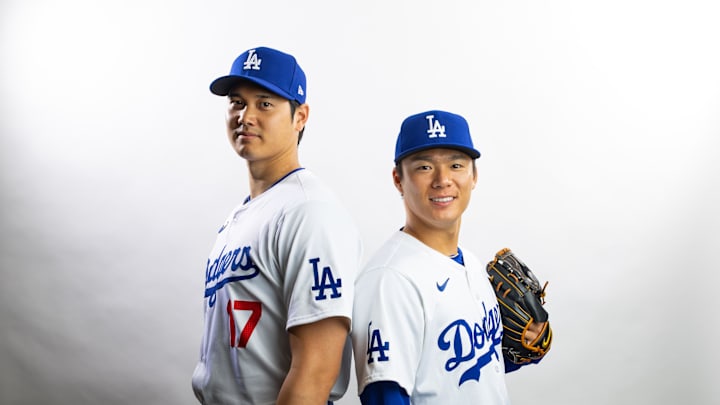 Feb 21, 2024; Glendale, AZ, USA; Los Angeles Dodgers designated hitter Shohei Ohtani (left) and pitcher Yoshinobu Yamamoto pose for a portrait during media day at Camelback Ranch. Mandatory Credit: Mark J. Rebilas-Imagn Images