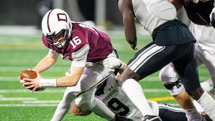 Ankeny Centennial's Mitchell Grider (9) makes a stop on Dowling's Joey Nahas (16) on Friday, Nov. 8, 2024, at Mediacom Stadium.