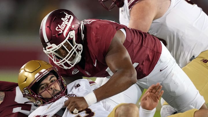 Sep 13, 2025; Stanford, California, USA; Stanford Cardinal linebacker Ernest Cooper (top) sacks Boston College Eagles quarterback Dylan Lonergan (bottom) during the third quarter at Stanford Stadium. Mandatory Credit: Darren Yamashita-Imagn Images Sep 13, 2025; Stanford, California, USA; Stanford Cardinal linebacker Ernest Cooper (top) sacks Boston College Eagles quarterback Dylan Lonergan (bottom) during the third quarter at Stanford Stadium. Mandatory Credit: Darren Yamashita-Imagn Images