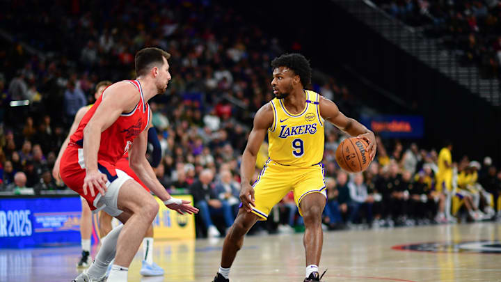Feb 4, 2025; Inglewood, California, USA; Los Angeles Lakers guard Bronny James (9) controls the ball against Los Angeles Clippers forward Drew Eubanks (15) during the second half at Intuit Dome. Mandatory Credit: Gary A. Vasquez-Imagn Images