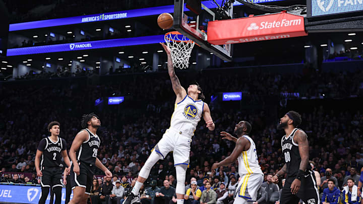 Feb 5, 2024; Brooklyn, New York, USA; Golden State Warriors forward Gui Santos (15) lays the ball up for basket during the second half against the Brooklyn Nets.