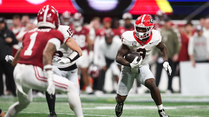 Dec 6, 2025; Atlanta, GA, USA; Georgia Bulldogs running back Nate Frazier (3) rushes as Alabama Crimson Tide defensive back Domani Jackson (1) defends during the third quarter during the 2025 SEC Championship game at Mercedes-Benz Stadium. Mandatory Credit: Brett Davis-Imagn Images