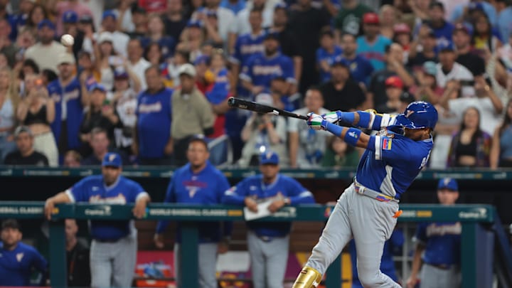 Mar 16, 2026; Miami, FL, United States; Venezuela first baseman Luis Arraez (2) hits an RBI single in the seventh inning against Italy
during a semifinal game of the 2026 World Baseball Classic at loanDepot Park. Mandatory Credit: Sam Navarro-Imagn Images