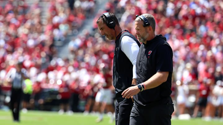Sep 13, 2025; Tuscaloosa, Alabama, USA; Wisconsin Badgers head coach Luke Fickell converses with an assistant during the second quarter against the Alabama Crimson Tide at Saban Field at Bryant-Denny Stadium. Mandatory Credit: David Leong-Imagn Images