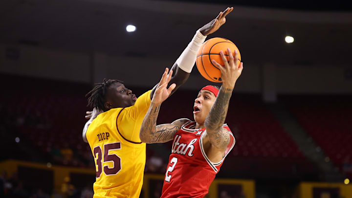 Utah Runnin' Utes guard Terrence Brown (2) drives to the basket against Arizona State Sun Devils center Massamba Diop (35) in the first half at Desert Financial Arena.
