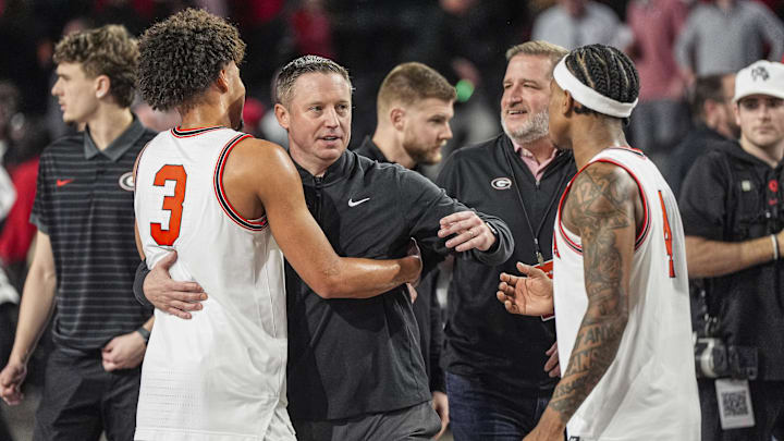 Jan 17, 2026; Athens, Georgia, USA; Georgia Bulldogs head coach Mike White reacts with guards Jordan Ross (3) and Marcus Millender (4) after Georgia defeated the Arkansas Razorbacks at Stegeman Coliseum. Mandatory Credit: Dale Zanine-Imagn Images