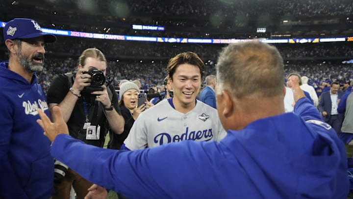 Los Angeles Dodgers pitcher Yoshinobu Yamamoto (18) celebrates with manager Dave Roberts (30) after defeating the Toronto Blue Jays in game seven of the 2025 MLB World Series at Rogers Centre on Saturday. Los Angeles Dodgers pitcher Yoshinobu Yamamoto (18) celebrates with manager Dave Roberts (30) after defeating the Toronto Blue Jays in game seven of the 2025 MLB World Series at Rogers Centre on Saturday.