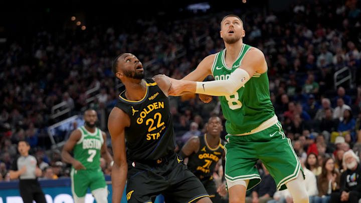 Jan 20, 2025; San Francisco, California, USA; Boston Celtics forward Kristaps Porzingis (8) and Golden State Warriors forward Andrew Wiggins (22) battle for position in the second quarter at the Chase Center. Mandatory Credit: Cary Edmondson-Imagn Images