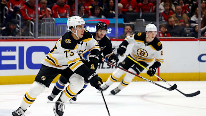 Dec 31, 2024; Washington, District of Columbia, USA; Boston Bruins defenseman Charlie McAvoy (73) skates with the puck against Washington Capitals center Connor McMichael (24) at Capital One Arena. Mandatory Credit: Peter Casey-Imagn Images