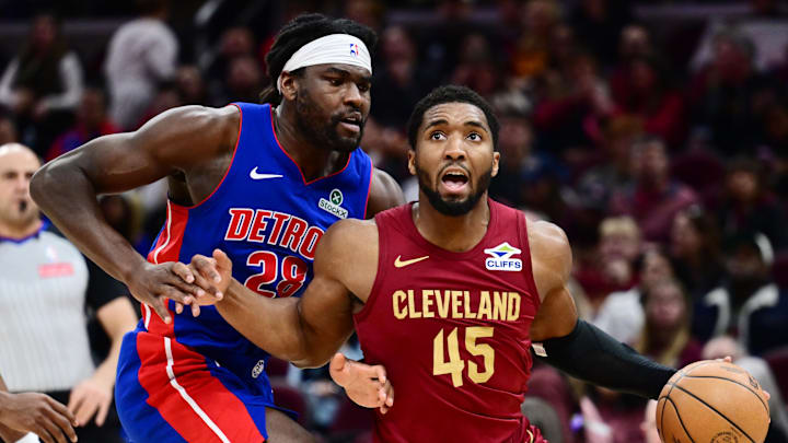 Jan 4, 2026; Cleveland, Ohio, USA; Cleveland Cavaliers guard Donovan Mitchell (45) drives to the basket against Detroit Pistons forward Isaiah Stewart (28) during the second half at Rocket Arena. Mandatory Credit: Ken Blaze-Imagn Images