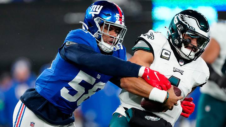 New York Giants linebacker Bobby Okereke (58) goes after Philadelphia Eagles quarterback Jalen Hurts (1) just before sacking him in the second quarter, Sunday, January 7, 2024.