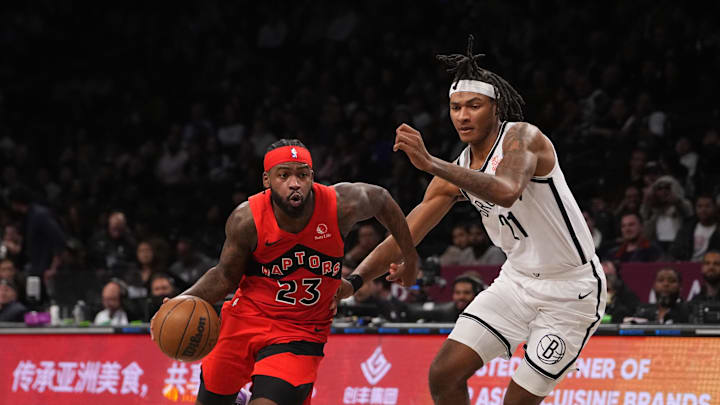 Oct 18, 2024; Brooklyn, New York, USA; Toronto Raptors guard Jamal Shead (23) dribbles the ball past Brooklyn Nets forward Noah Clowney (21) during the second half at Barclays Center. Mandatory Credit: Gregory Fisher-Imagn Images