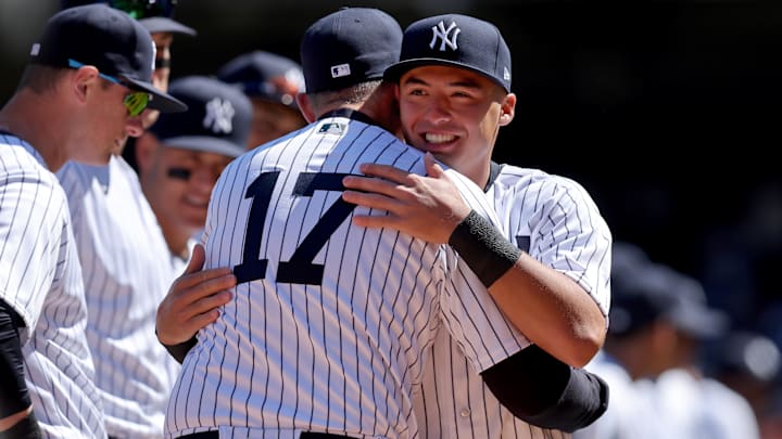 Mar 30, 2023; Bronx, New York, USA; New York Yankees shortstop Anthony Volpe (11) hugs manager Aaron Boone (17) during introductions before an opening day game against the San Francisco Giants at Yankee Stadium. Mandatory Credit: Brad Penner-Imagn Images