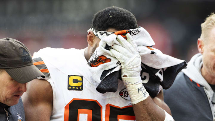 Dec 15, 2024; Cleveland, Ohio, USA; Cleveland Browns defensive end Myles Garrett (95) holds a towel over his face as he is escorted to the locker room following an injury during the second quarter against the Kansas City Chiefs at Huntington Bank Field. Mandatory Credit: Scott Galvin-Imagn Images