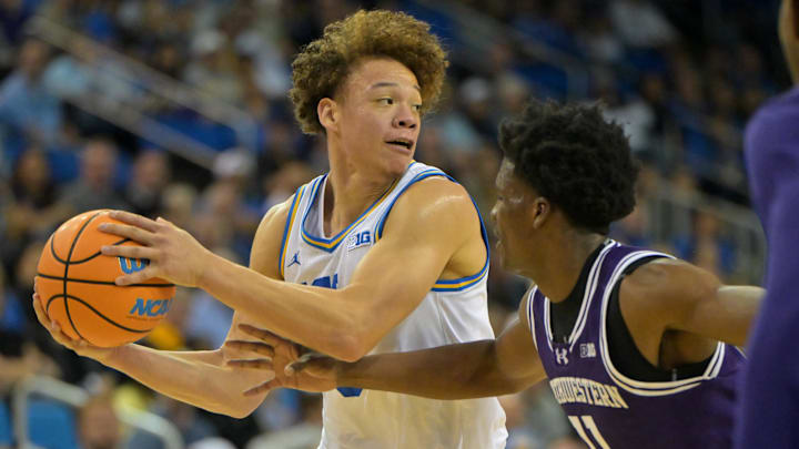 Jan 24, 2026; Los Angeles, California, USA; UCLA Bruins guard Trent Perry (0) is defended by Northwestern Wildcats guard Jordan Clayton (11) in the first half at Pauley Pavilion presented by Wescom Financial. Mandatory Credit: Jayne Kamin-Oncea-Imagn Images