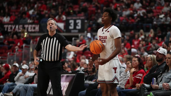 Dec 28, 2025; Lubbock, Texas, USA;  Big 12 official; Doug Sirmons hands the ball to Texas Tech Red Raiders forward Leon Horner (6) in the second half of the game against the Winthrop Eagles at United Supermarkets Arena. Mandatory Credit: Michael C. Johnson-Imagn Images