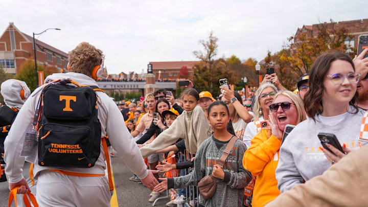 A Tennessee football player high-fives fans at Vol Walk before a NCAA football game between Tennessee Volunteers and New Mexico State Aggies at Neyland Stadium in Knoxville, Tenn., on Nov. 15, 2025.