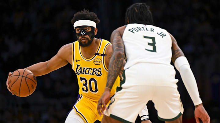Mar 20, 2025; Los Angeles, California, USA; Los Angeles Lakers guard Jordan Goodwin (30) looks to pass against Milwaukee Bucks guard Kevin Porter Jr. (3) during the second half at Crypto.com Arena. Mandatory Credit: Jonathan Hui-Imagn Images