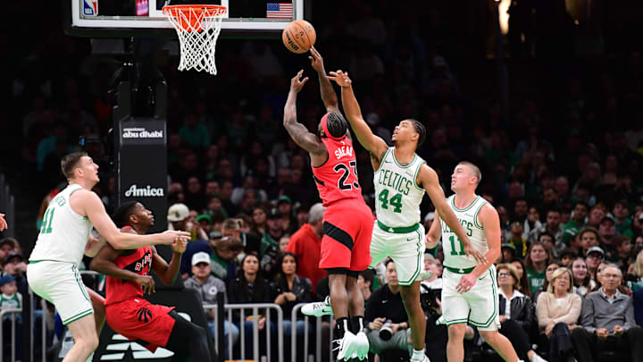 Oct 13, 2024; Boston, Massachusetts, USA;  Boston Celtics guard Jaden Springer (44) fouls Toronto Raptors guard Jamal Shead (23) during the first half at TD Garden. Mandatory Credit: Bob DeChiara-Imagn Images