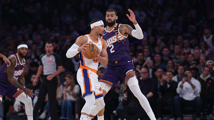 New York Knicks guard Josh Hart is guarded by Phoenix Suns center Nick Richards.