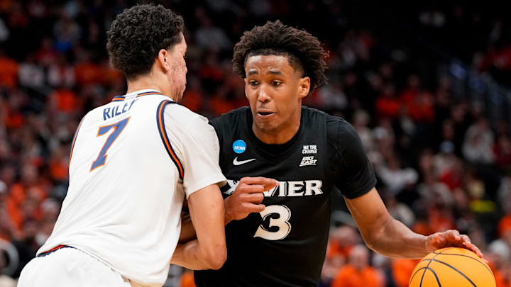 Xavier Musketeers guard Dailyn Swain (3) drives against Illinois Fighting Illini forward Will Riley (7) in the second half of the NCAA Tournament First Round game between the Illinois Fighting Illini and the Xavier Musketeers at Fiserv Forum in Milwaukee on Friday, March 21, 2025. Xavier was eliminated from the tournament, losing 86-73, to Illinois. Xavier Musketeers guard Dailyn Swain (3) drives against Illinois Fighting Illini forward Will Riley (7) in the second half of the NCAA Tournament First Round game between the Illinois Fighting Illini and the Xavier Musketeers at Fiserv Forum in Milwaukee on Friday, March 21, 2025. Xavier was eliminated from the tournament, losing 86-73, to Illinois.