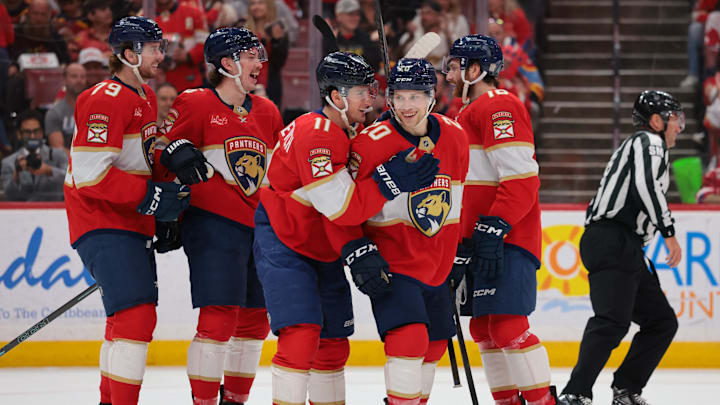 Apr 15, 2026; Sunrise, Florida, USA; Florida Panthers defenseman Mike Benning (20) celebrates with right wing MacKie Samoskevich (11) after scoring against the Detroit Red Wings during the second period at Amerant Bank Arena. Mandatory Credit: Sam Navarro-Imagn Images