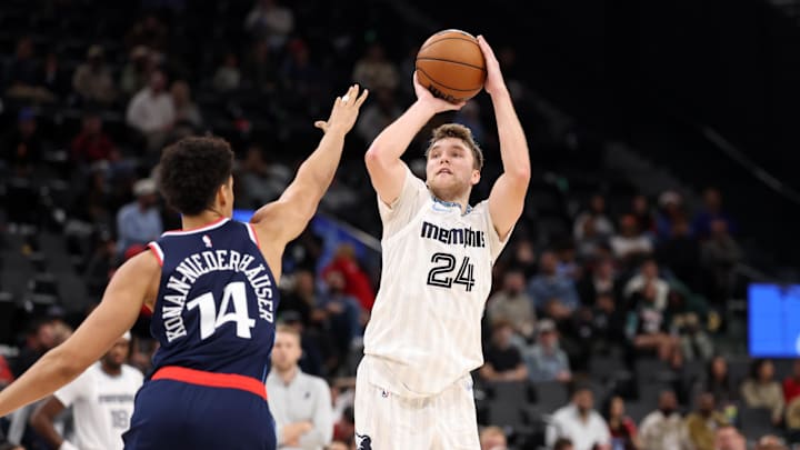 Dec 15, 2025; Inglewood, California, USA;  Memphis Grizzlies guard Cam Spencer (24) shoots a three point basket against Los Angeles Clippers center Yanic Konan Niederhauser (14) during the fourth quarter at Intuit Dome. Mandatory Credit: Kiyoshi Mio-Imagn Images