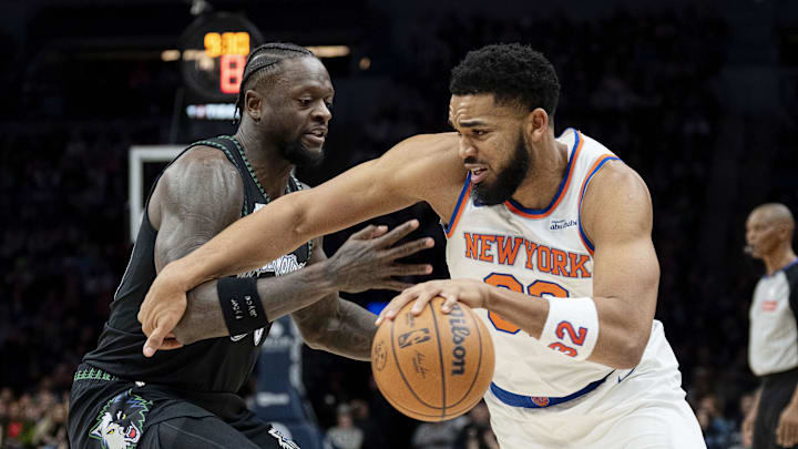 Dec 23, 2025; Minneapolis, Minnesota, USA; New York Knicks center Karl-Anthony Towns (32) dribbles the ball past Minnesota Timberwolves forward Julius Randle (30) in the first half at Target Center. Mandatory Credit: Jesse Johnson-Imagn Images