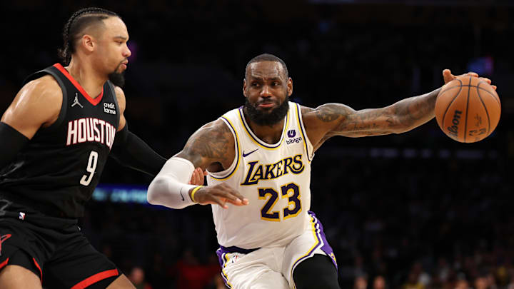 Nov 19, 2023; Los Angeles, California, USA;  Los Angeles Lakers forward LeBron James (23) dribbles against Houston Rockets forward Dillon Brooks (9) during the second quarter at Crypto.com Arena. Mandatory Credit: Kiyoshi Mio-Imagn Images