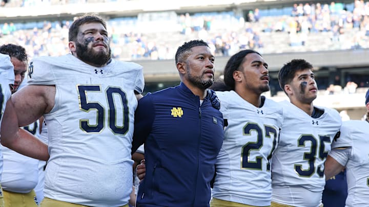 Oct 26, 2024; East Rutherford, New Jersey, USA; Notre Dame Fighting Irish head coach Marcus Freeman sings the Notre Dame alma mater with teammates after the game against the Navy Midshipmen at MetLife Stadium. Mandatory Credit: Vincent Carchietta-Imagn Images