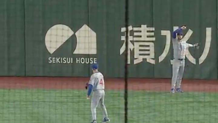 Crow-Armstrong (#4) prepares to throw Ohtani's home run ball back into the stands to a young fan. 