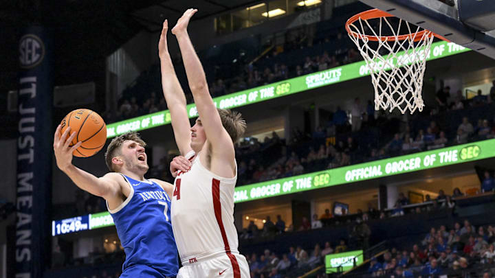 Mar 14, 2025; Nashville, TN, USA;  Kentucky Wildcats forward Andrew Carr (7) shoots over  Alabama Crimson Tide forward Grant Nelson (4) during the second half at Bridgestone Arena. Mandatory Credit: Steve Roberts-Imagn Images