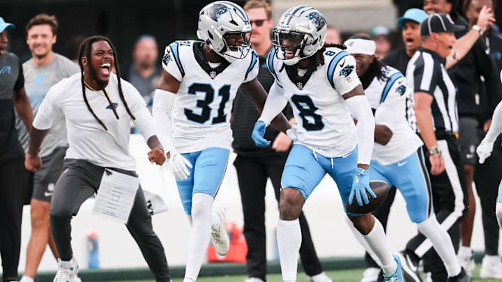 Oct 19, 2025; East Rutherford, New Jersey, USA; Carolina Panthers cornerback Jaycee Horn (8) celebrates an interception intended for New York Jets wide receiver Josh Reynolds (83) in the fourth quarter at MetLife Stadium. Mandatory Credit: Vincent Carchietta-Imagn Images