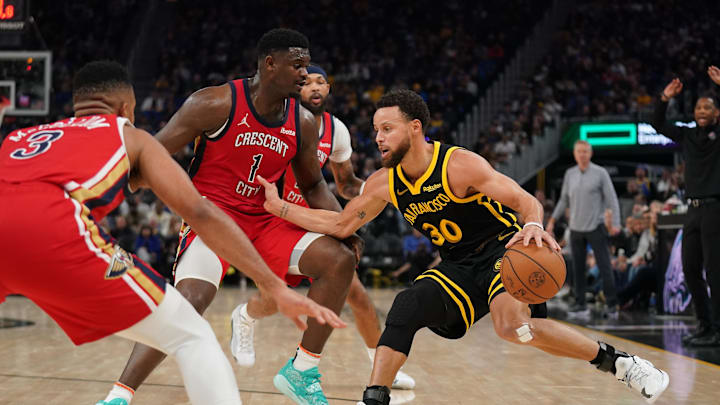 Jan 10, 2024; San Francisco, California, USA; Golden State Warriors guard Stephen Curry (30) dribbles the ball next to New Orleans Pelicans forward Zion Williamson (1) in the second quarter at the Chase Center. Mandatory Credit: Cary Edmondson-Imagn Images